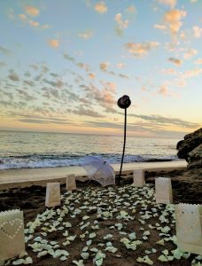 Evening sky, beach with confetti and candle bags