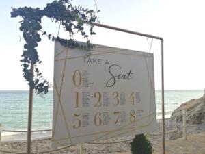 a wedding table plan with sea in the background